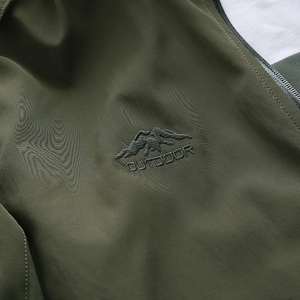 Men's olive green outdoor hooded windbreaker with detailed mountain embroidery