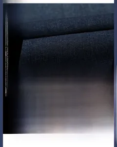 Detailed macro view of dark blue denim fabric showing breathable and soft texture