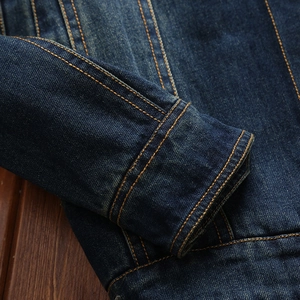 Classic dark blue denim jacket for men featuring orange contrast stitching details