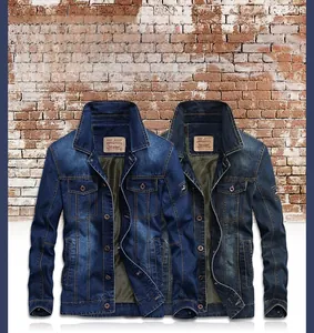 Close-up of dual-color denim jackets featuring classic flap pockets and vintage brick wall