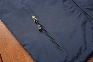 Detail shot of navy blue casual vest featuring high-quality metal zipper and puller