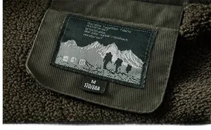 Detail of fleece lining and corduroy collar with embroidered logo on men jacket