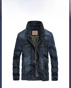 Detail of blue denim jacket showing washed cat-whisker effect and metal buttons