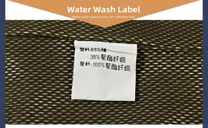 Macro detail of clothing care label showing 65% cotton and 35% polyester fabric composition