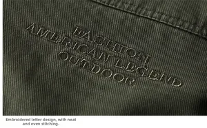 Close-up of heavy embroidery and fine stitching on army green military outdoor jacket