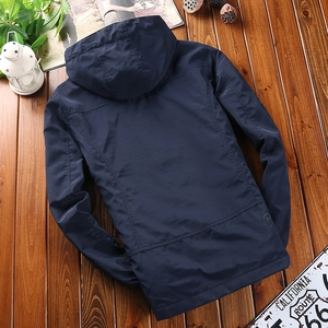 Navy blue men's hooded outdoor windbreaker jacket back view on rustic wooden background