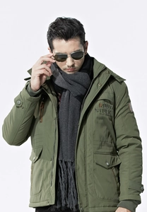 Detail of olive green hooded parka with Rough Stock embroidery and winter scarf style