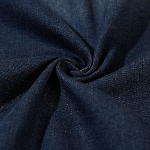 Close-up of premium dark blue denim fabric texture for men's loose casual jacket