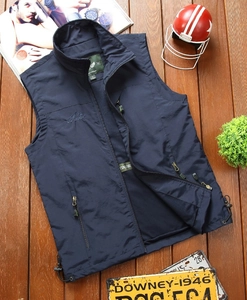Detail of navy blue outdoor vest with embroidered logo, zipper pocket and mesh lining