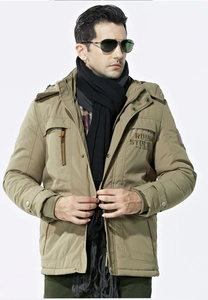 Detail of khaki hooded winter parka featuring ROUGH STOCK embroidery and utility pockets
