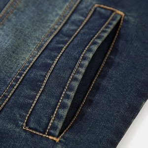 Close-up of vintage blue denim jacket featuring high-density twill fabric and retro wash