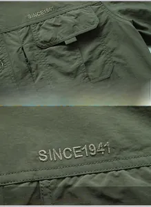 Detail of military green shirt with waterproof ripstop fabric and embroidered chest pocket