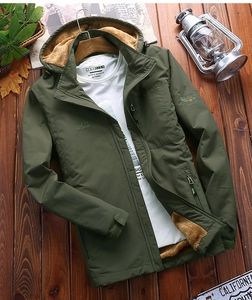 Detail of army green winter jacket with thick camel fleece lining and outdoor embroidery