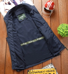 Detail of dark blue outdoor vest featuring breathable mesh lining and zipper