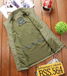 Detail of army green outdoor vest showing breathable mesh lining and brand label