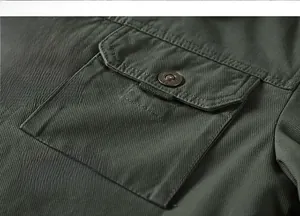 Detail of army green cargo jacket featuring a flap pocket with vintage metal button
