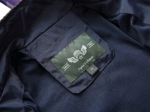 Detail of dark blue men's vest collar with mesh lining and authentic size label