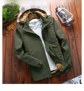 Detail of army green winter jacket with plush brown lining and outdoor embroidery