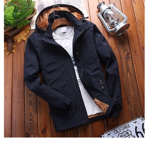 Detail of dark blue winter jacket with warm brown fleece lining and outdoor embroidery