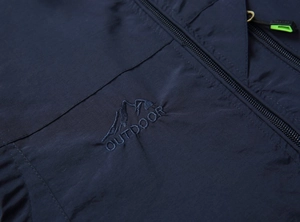 Close-up of navy outdoor vest with durable fabric and mountain outdoor embroidery