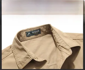 Close-up of the khaki outdoor shirt collar with fine stitching and black neck label