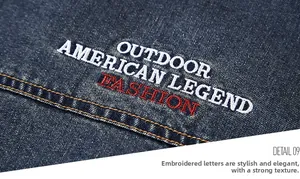 Detail view of high-quality denim texture with red and white outdoor themed embroidery