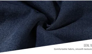 Close-up of deep blue denim fabric texture showing the twill weave and soft thickness