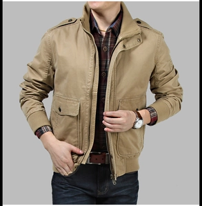 Detail view of khaki military jacket featuring epaulets and large flap pockets