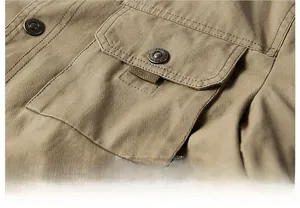 Detail of khaki outdoor jacket showing flap pocket with vintage metal fashion buttons