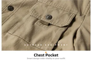 Detail of khaki outdoor jacket chest pocket with vintage metal button and twill texture