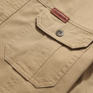 Close-up of khaki military style twill shirt with cargo pocket and outdoor leather patch