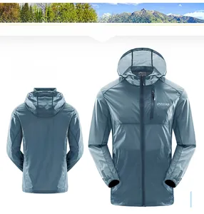 Detail of gray-blue lightweight outdoor windbreaker featuring zippered chest pocket and logo