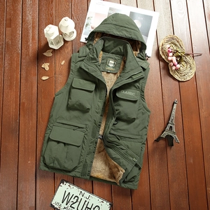 Detailed view of dark green outdoor vest with thick lamb wool lining and multi-pocket design