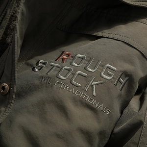 Men's olive green outdoor thermal parka featuring detailed vintage chest embroidery