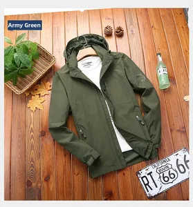 Detail of army green hooded windbreaker with functional pockets and sleeve patch