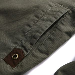 Army green casual jacket detail showing side pocket with fashion metal eyelet and canvas patch