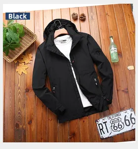 Detailed flat lay of a black hooded windbreaker jacket with functional zipper pockets