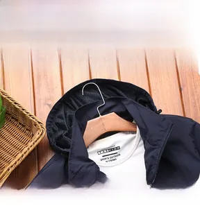 Macro view of navy blue hooded jacket collar with precision stitching and mesh lining