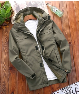 Detail of army green outdoor jacket with breathable mesh lining and adjustable velcro cuffs