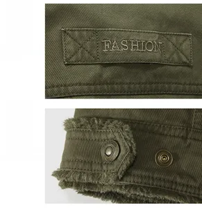 Detail showing FASHION embroidery on webbing, metal snap button, and warm fleece lining