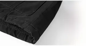 Detail of the hem on a thick fleece-lined jacket showing durable stitching and warm lining