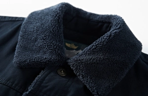 Detail of winter jacket showing plush lamb wool collar and bronze metal snap buttons