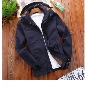 Detail of dark blue men's windbreaker with brown mesh lining on a wooden hanger
