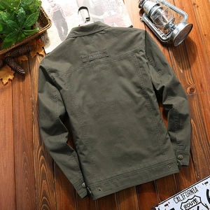 Army green men's cotton military jacket with vintage outdoor styling on wood background