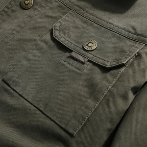 Army green military cotton jacket detail featuring a flap pocket with an engraved button