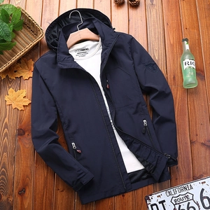 Navy blue hooded waterproof outdoor jacket for men with mesh lining on wood background