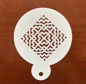Detail of white PET cake stencil with complex geometric rhombus pattern and handle