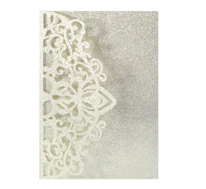 Macro view of champagne gold glitter laser cut lace invitation with intricate hollow floral details