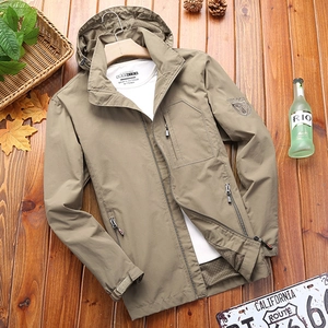 Men's khaki hooded waterproof jacket with chest zipper pockets on wood background