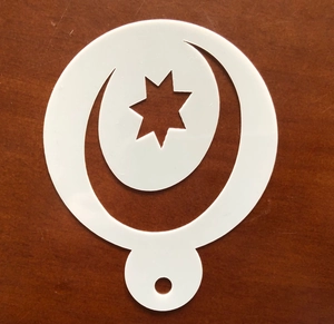 Detail of laser-cut moon and star stencil for DIY holiday cake art and coffee spray painting